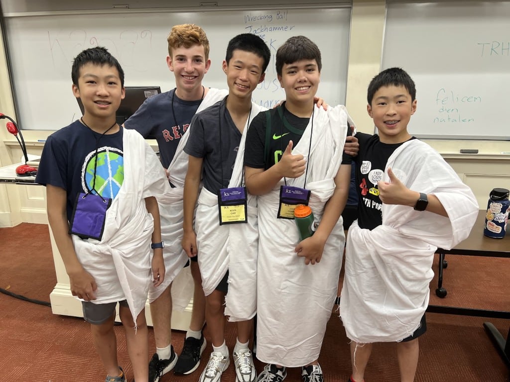 Five boys in makeshift togas pose for a photo